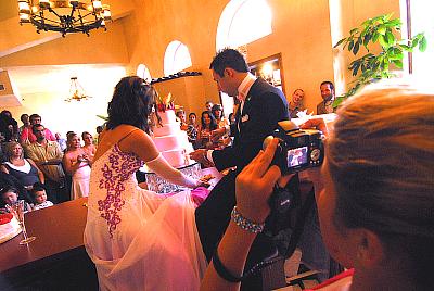 Jessica Thompson Witt and Tony Witt. Cutting the Cake in the lobby of the Madrid. Tony's Daughter is taking a picture