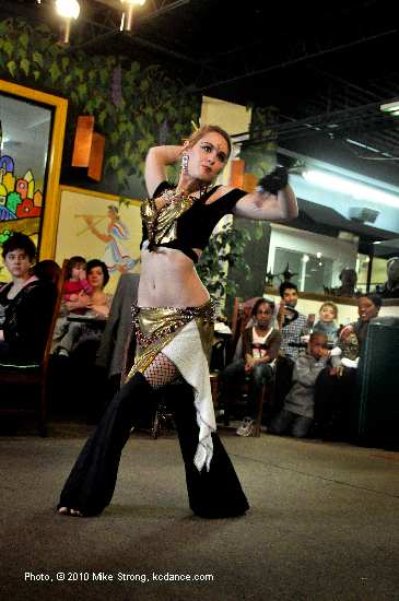 Dharma, with a tribal routine and with friends watching from directly behind her (right).