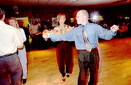 Two students dancing at a friday night party.