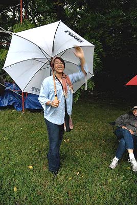 City In Motion board chair person Vanessa Vaughn-West with umbrella just before calling the show for rain and moving the show date to sunday