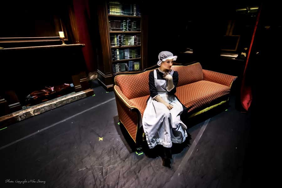 The incredibly famous and enigmatic "Woman on a Couch" image - Annie Cook in maid costume, preshow behind the curtain.